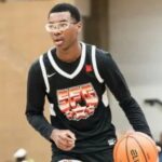 Bryce James playing basketball in a black SFG jersey during a game
