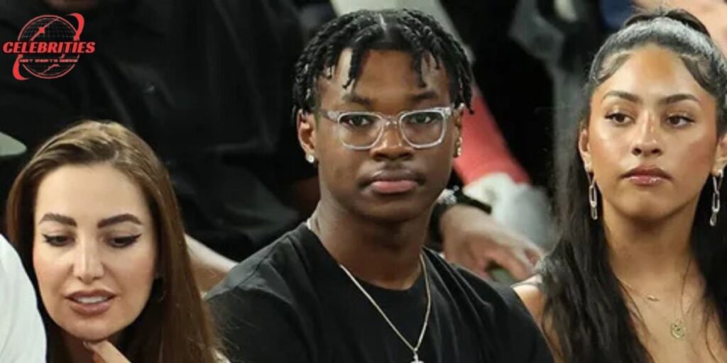 Bryce James seated at an event with friends.